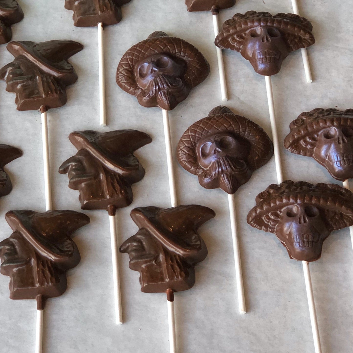 Rows of Day of the Dead luster chocolate suckers