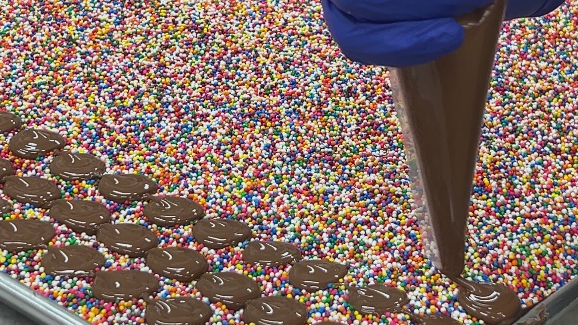 Load video: Hand-piping chocolate onto nonpareils