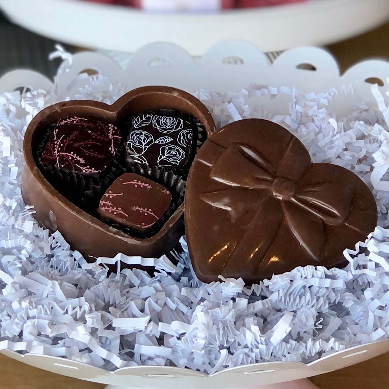 handcrafted chocolate heart box with lid, and 3 truffles inside